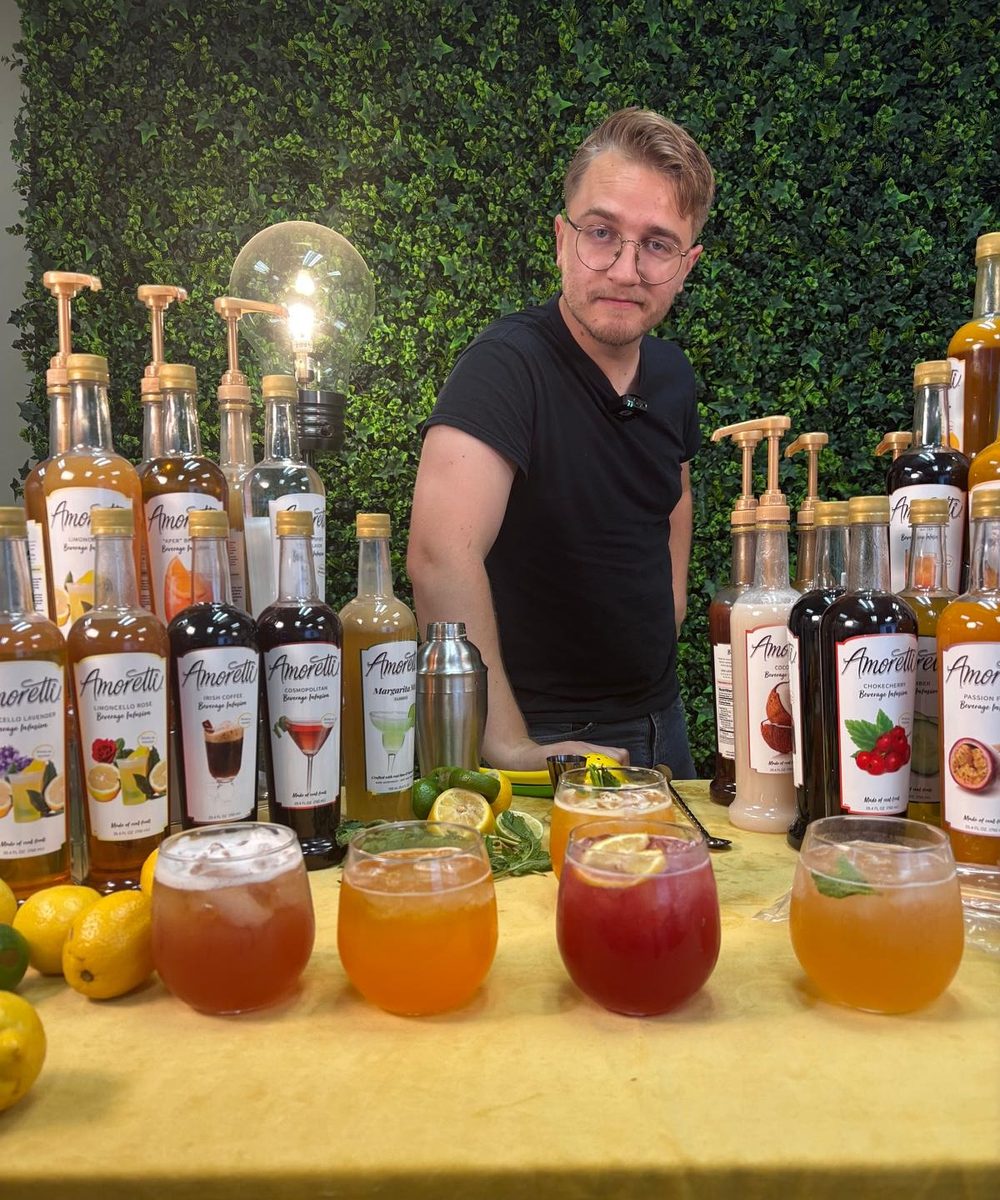 Host behind a staged product table in DCA’s live selling studio