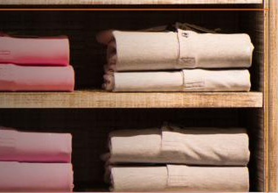 Folded apparel stacked on retail shelving