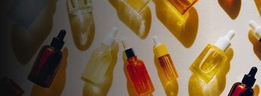Row of skincare serum bottles photographed from above
